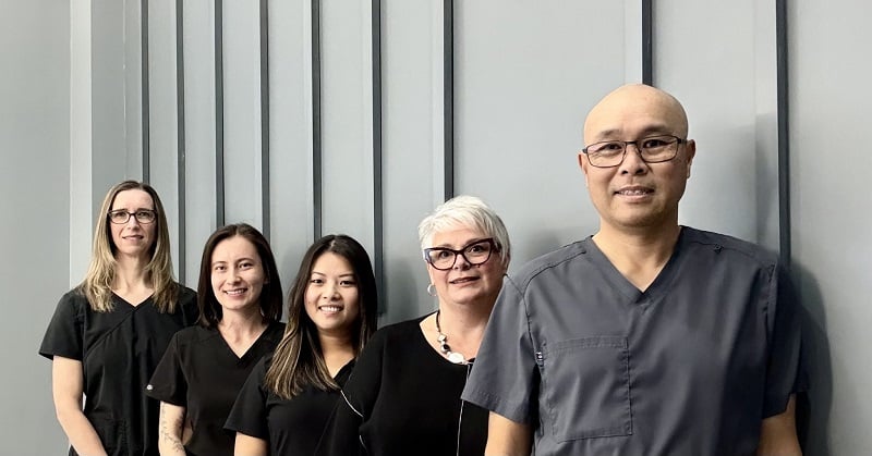 Doctor and team posing together